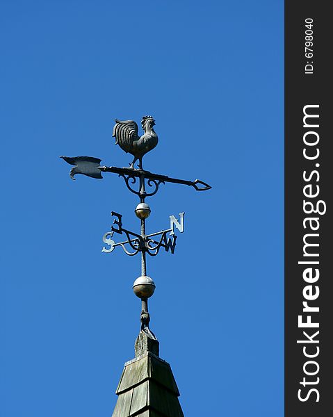 Old historic roof with weather vane