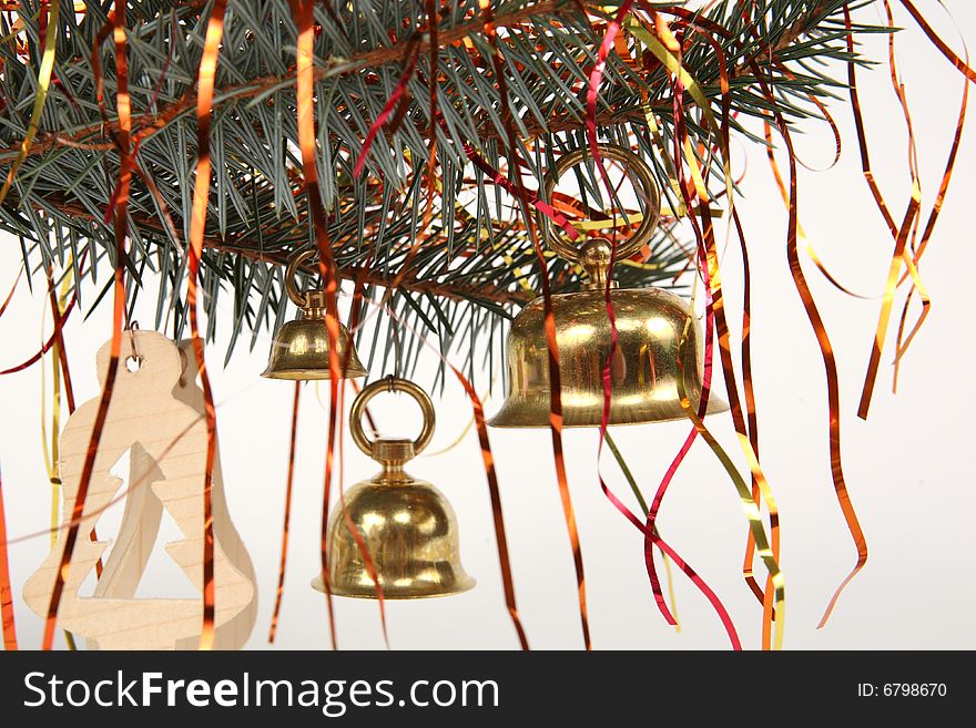 Three golden hand bells on christmas tree