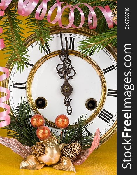 New Year's decoration with an antique clock and a firtree branch