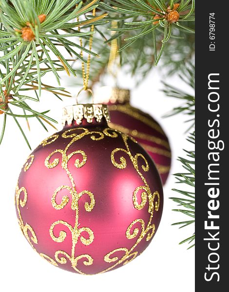 Fir tree branch with decoration on a white background. Close up. Christmas decoration.