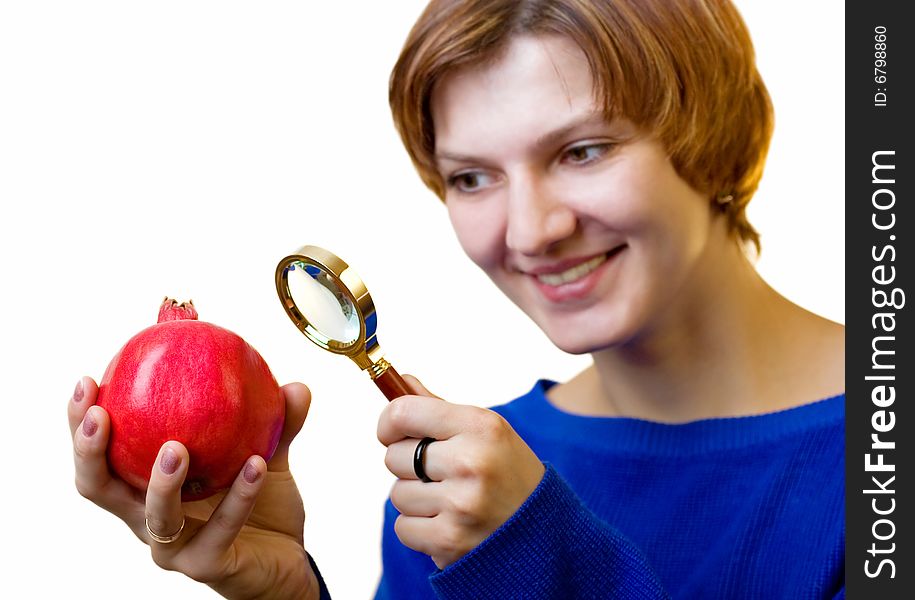 A girl with pomegranate and magnifying glass
