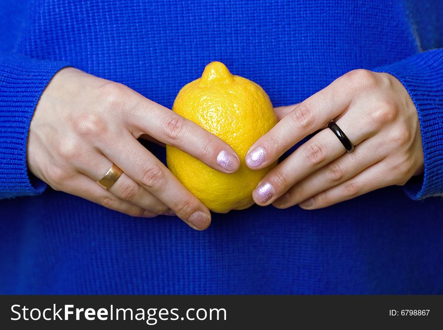 Hands of a girl carrying a lemon. Hands of a girl carrying a lemon