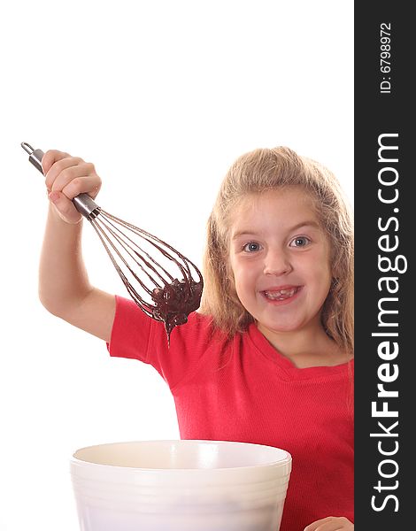 Shot of a happy little girl mixing brownie batter vertical