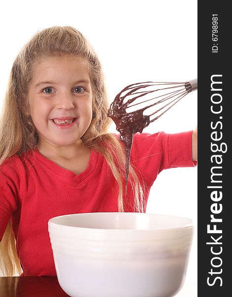 Happy little girl mixing brownie batter vertical upclose isolated on white