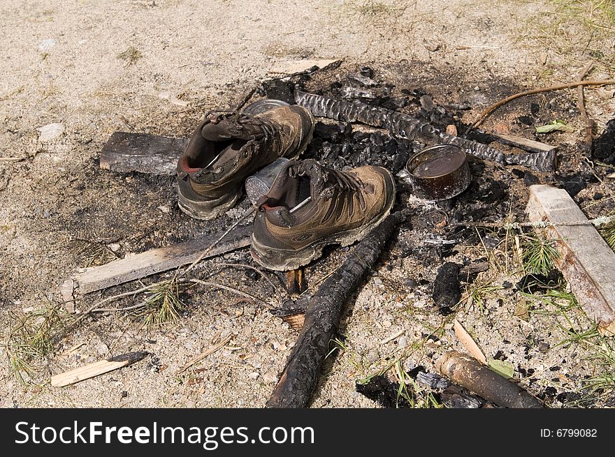 Burnt jogging shoes in a bonfire (garbage)