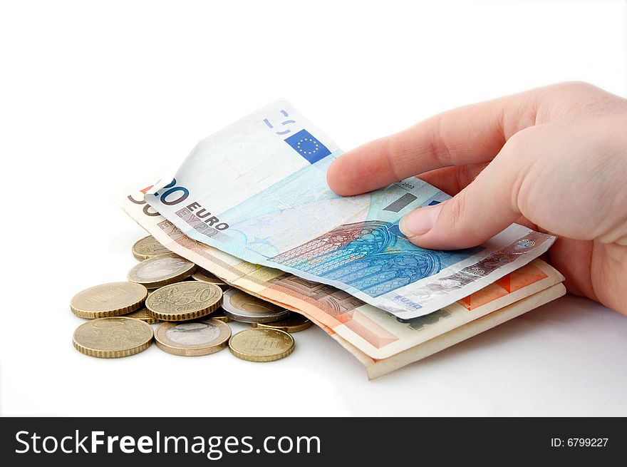 An isolated image of Euro Coins and Notes in a hand