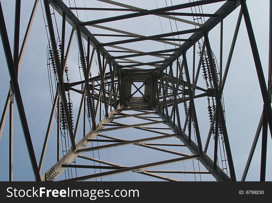 Bottom view of metal electrical pylon with wires