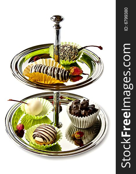 Two-tiered plate with chocolate candies. Two-tiered plate with chocolate candies
