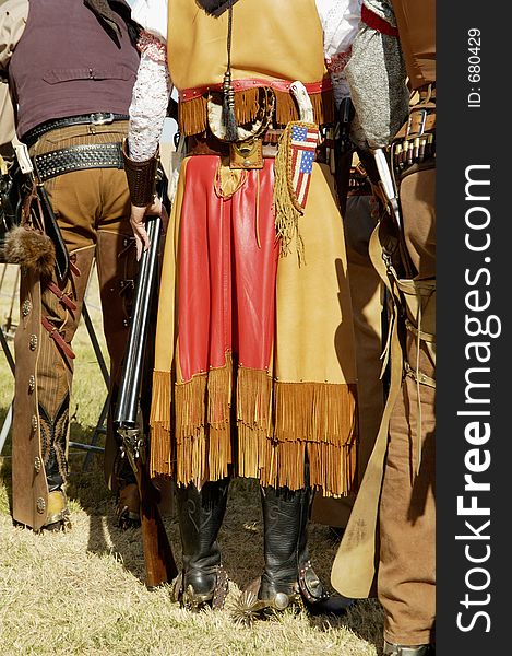 Contestants in period dress wait to compete in a cowboy action shooting event. Contestants in period dress wait to compete in a cowboy action shooting event.