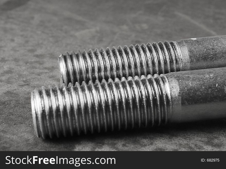 Two large bolts, screws in black/white. Two large bolts, screws in black/white