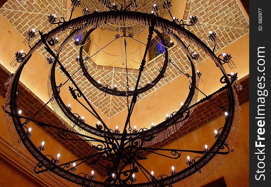 Enormous iron chandelier hanging in the foyer. Enormous iron chandelier hanging in the foyer