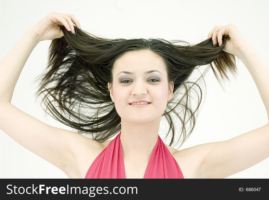 Young woman throwing her hair on her back. Young woman throwing her hair on her back