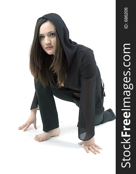 Gothic teenager girl dressed in a black outfit, practicing the moves for a modern dance. Gothic teenager girl dressed in a black outfit, practicing the moves for a modern dance.