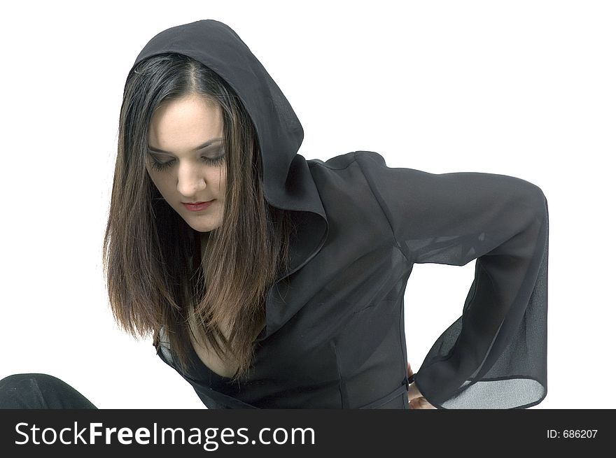 Gothic young woman wearing a hood, catching her breath after a modern dance exercise.
