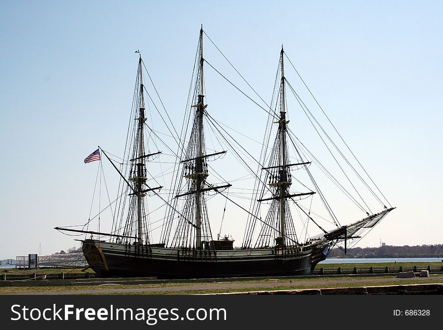 Tall ship and mast against a blue sky