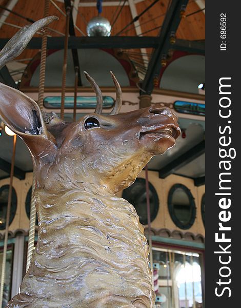 A close-up of a carousel deer