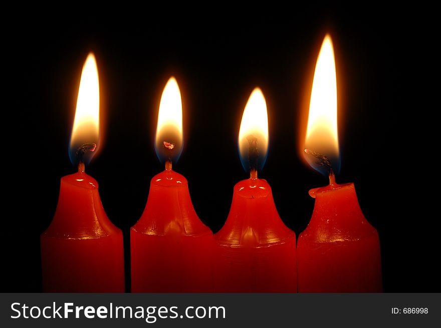 Four red candles burning