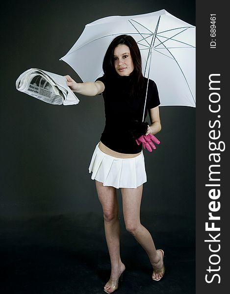 Young girl handing out a paper from under a white a umbrella. Young girl handing out a paper from under a white a umbrella