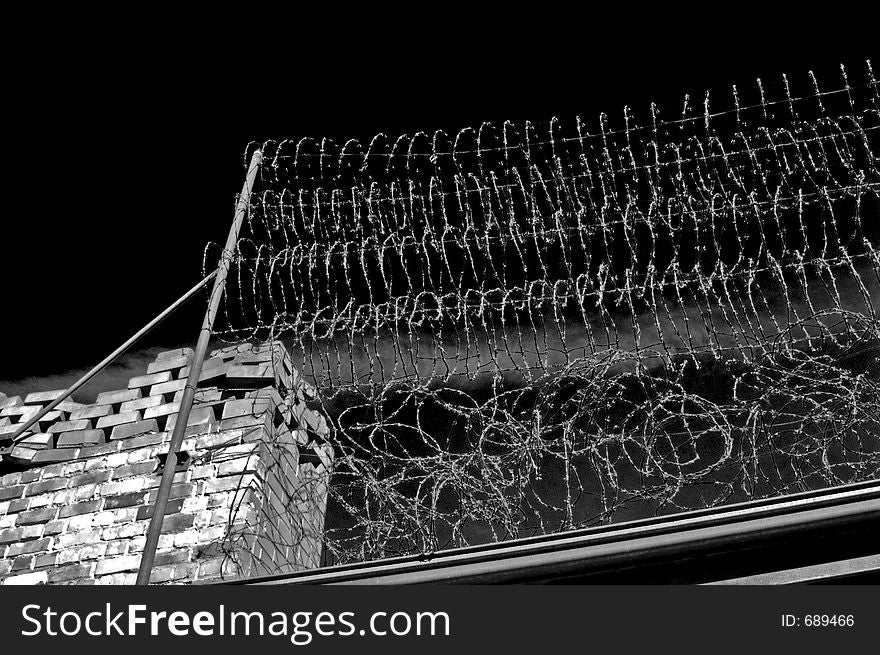 Razor sharp barbed wire atop of a perimeter fence at the Adelaide gaol (black and white). Razor sharp barbed wire atop of a perimeter fence at the Adelaide gaol (black and white)