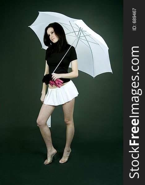 Young girl walking looking sad under an umbrella. Young girl walking looking sad under an umbrella