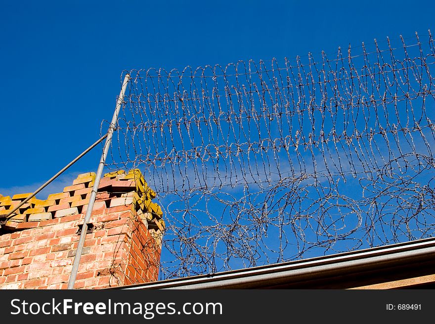 A razor sharp barbed wire fence atop of a perimeter fence at the Adelaide gaol (colour).