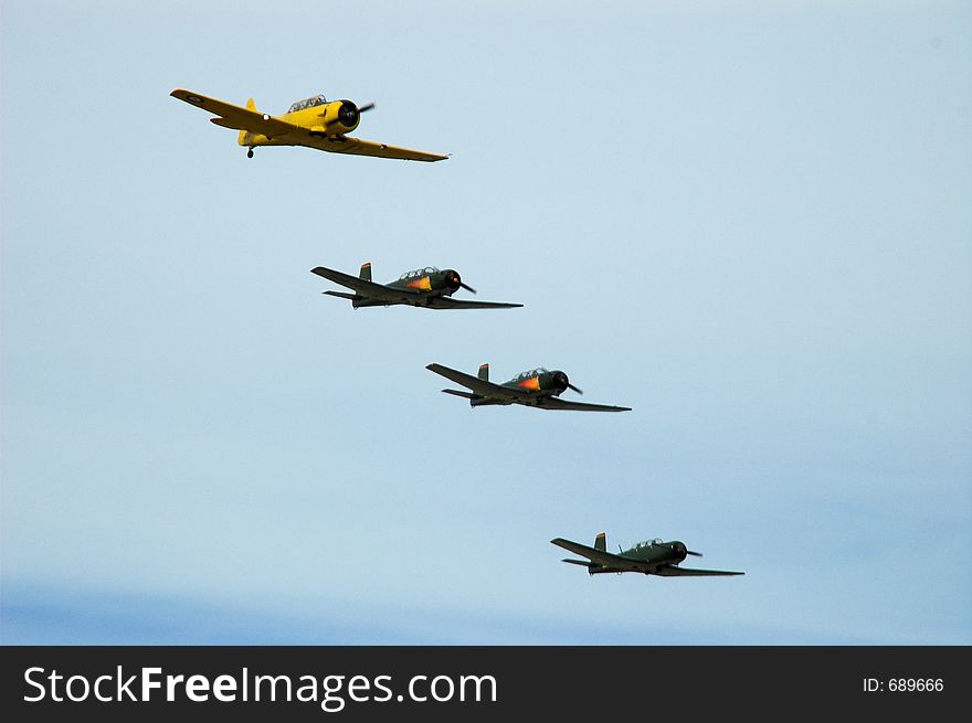 A Texan AT6 leads a group of Nanchang warplanes in group formation. A Texan AT6 leads a group of Nanchang warplanes in group formation.