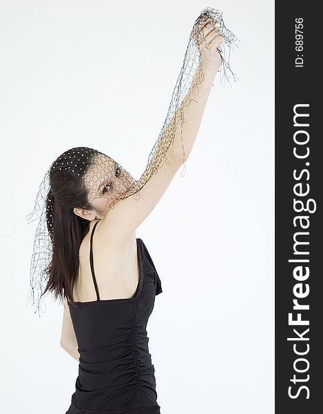 Pretty young brunette with a fresh, fit look, dressed in a short, light, black dress and playing with a net shawl over a white studio background, performs various postures and expressions. Pretty young brunette with a fresh, fit look, dressed in a short, light, black dress and playing with a net shawl over a white studio background, performs various postures and expressions
