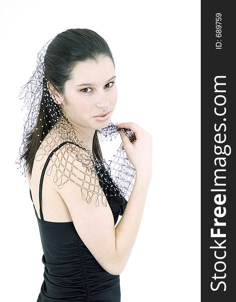 Pretty young brunette with a fresh, fit look, dressed in a short, light, black dress and playing with a net shawl over a white studio background, performs various postures and expressions. Pretty young brunette with a fresh, fit look, dressed in a short, light, black dress and playing with a net shawl over a white studio background, performs various postures and expressions