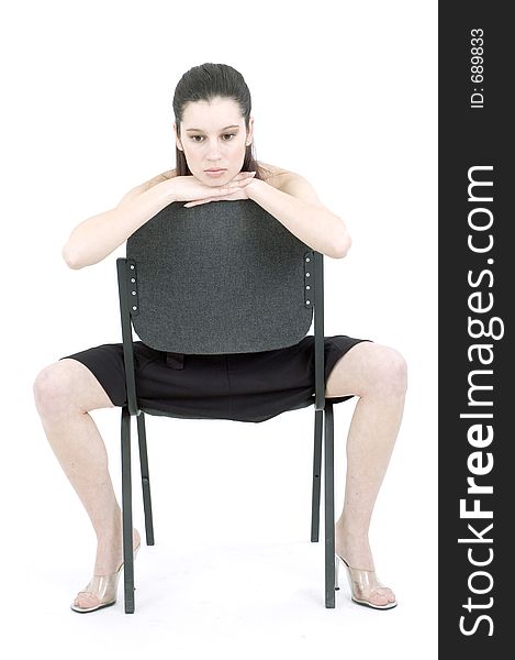 Young woman on a chair thinking. Young woman on a chair thinking