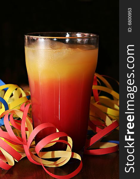 Cocktail (Tequila Sunrise) with blow-outs on a table