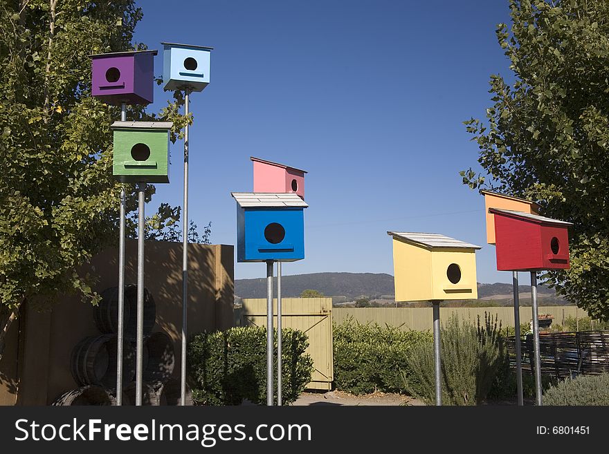 Bright colored bird houses on a sunny day. Bright colored bird houses on a sunny day
