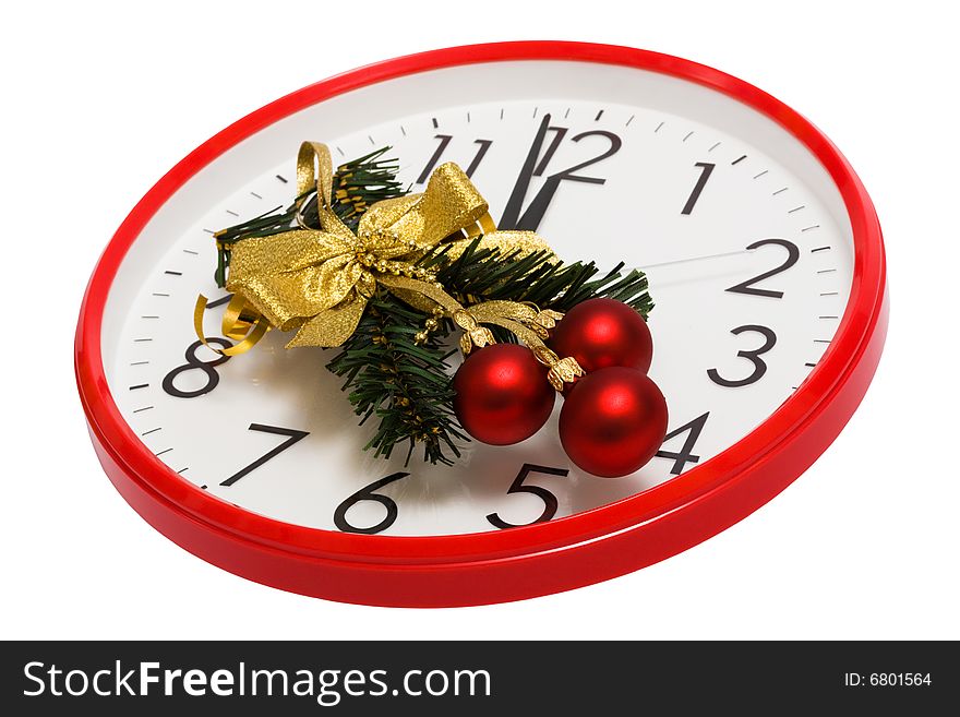 Christmas-tree decoration with red spheres on a background of clock
