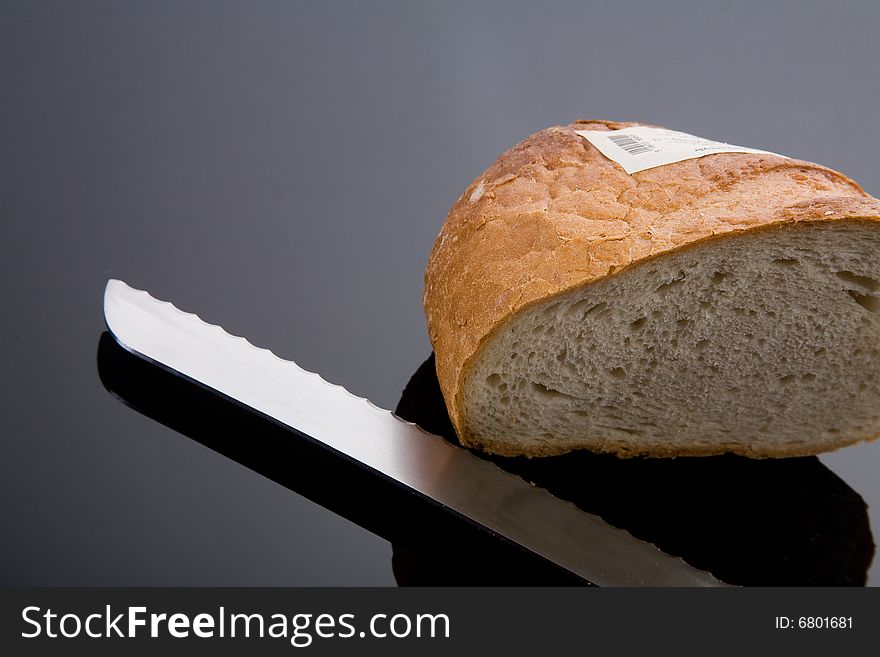 Bread and knife on dark gray background