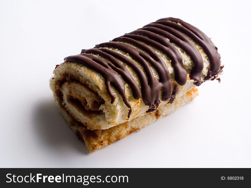 Tasty creamy chocolate roll at white background. Tasty creamy chocolate roll at white background