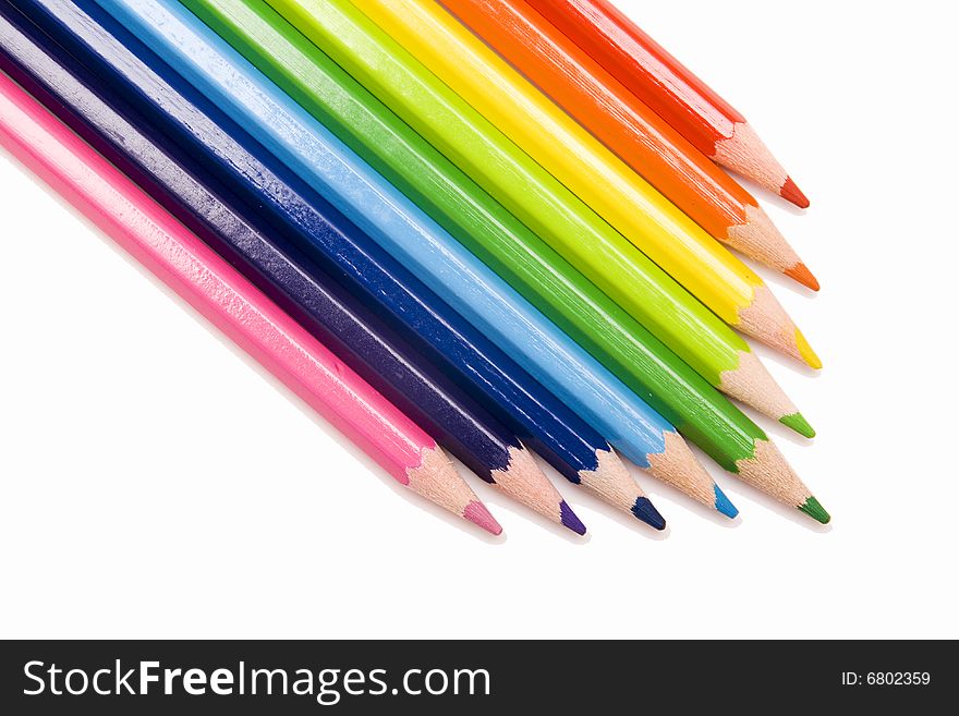 Colored pencils on white background. Colored pencils on white background