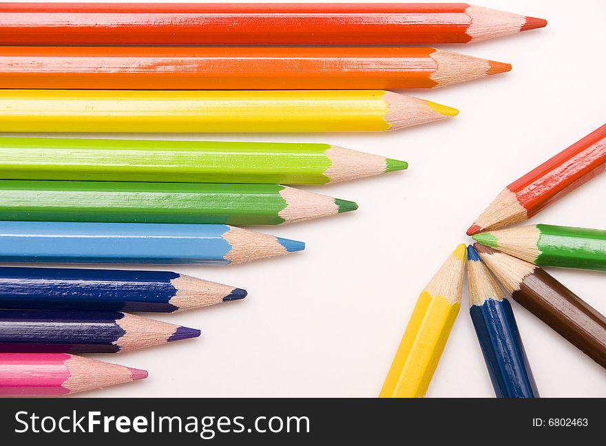 Colored pencils on white background. Colored pencils on white background