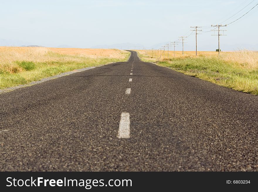 Endless tarred country road in rural South Africa disappearing into the horizon. Endless tarred country road in rural South Africa disappearing into the horizon