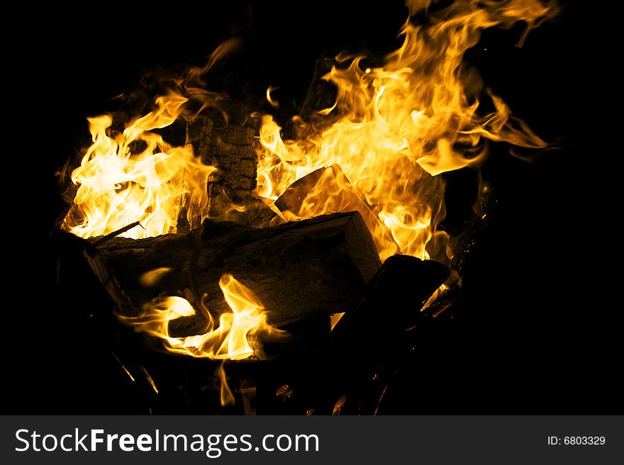 Fire flames raising in a dark background
