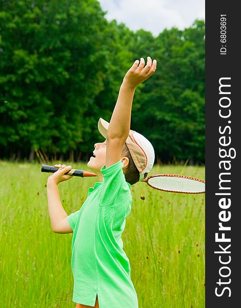 Cute kid playing badminton outdoors