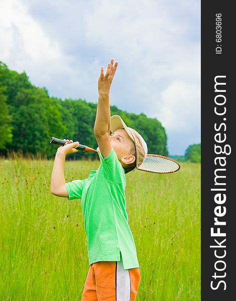 Cute kid playing badminton outdoors