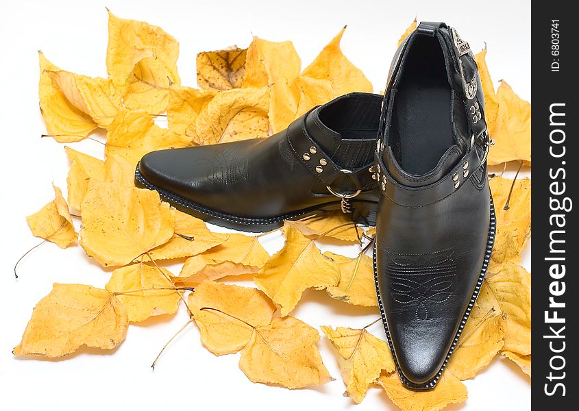 Man shoes on Fall leafs isolated on white