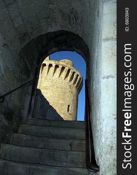 Tower of a castle trough a arche in Palma de Mallorca in Spain. Tower of a castle trough a arche in Palma de Mallorca in Spain