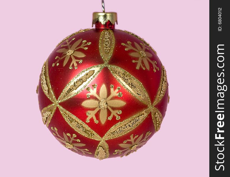 Red and gold Christmas ornaments against pink background. Red and gold Christmas ornaments against pink background