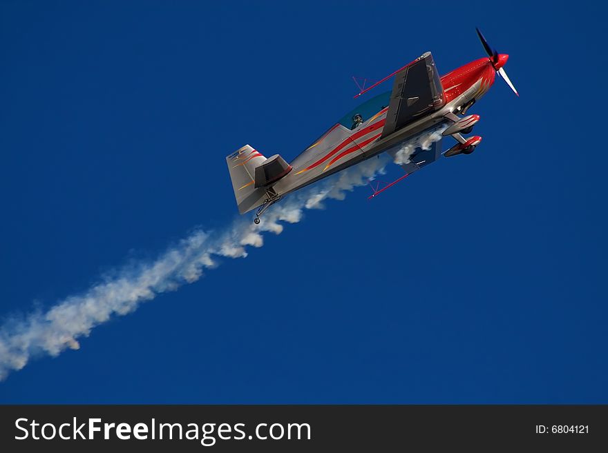 Red and white airplane in the sky