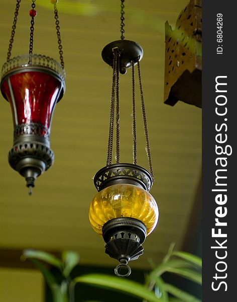 Colored glass globe lamps hanging from a patio ceiling. Colored glass globe lamps hanging from a patio ceiling