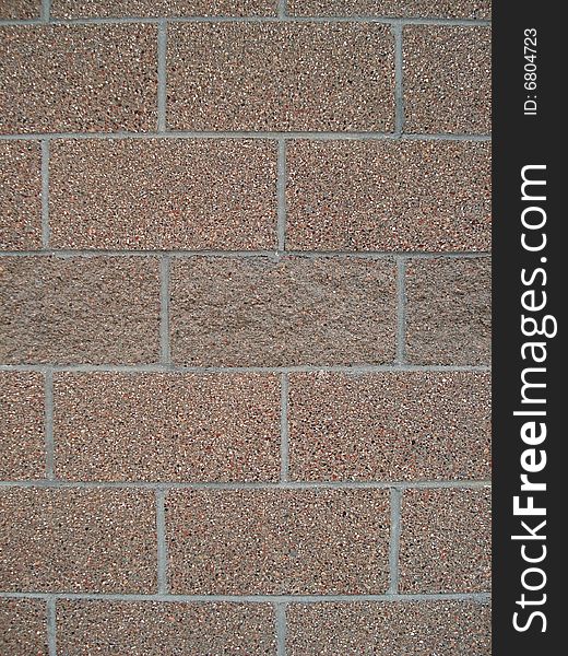 A cement wall has a distinct pattern of stacked bricks.  This image would make a good background or wallpaper image. A cement wall has a distinct pattern of stacked bricks.  This image would make a good background or wallpaper image.