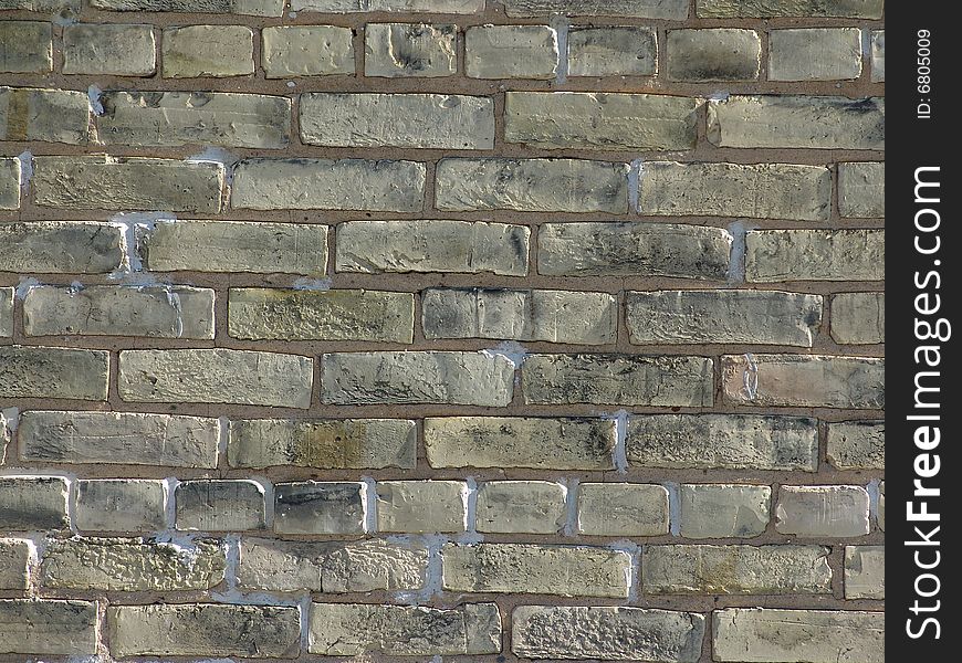 Weathered brick wall with neutral colored bricks