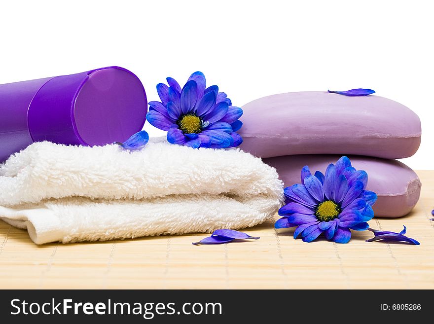 Spa essentials, soap and towel with blue flowers