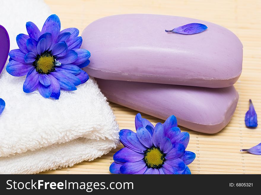 Spa essentials, soap and towel with blue flowers