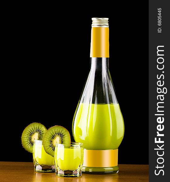 Bottle and glass with kiwi liquor